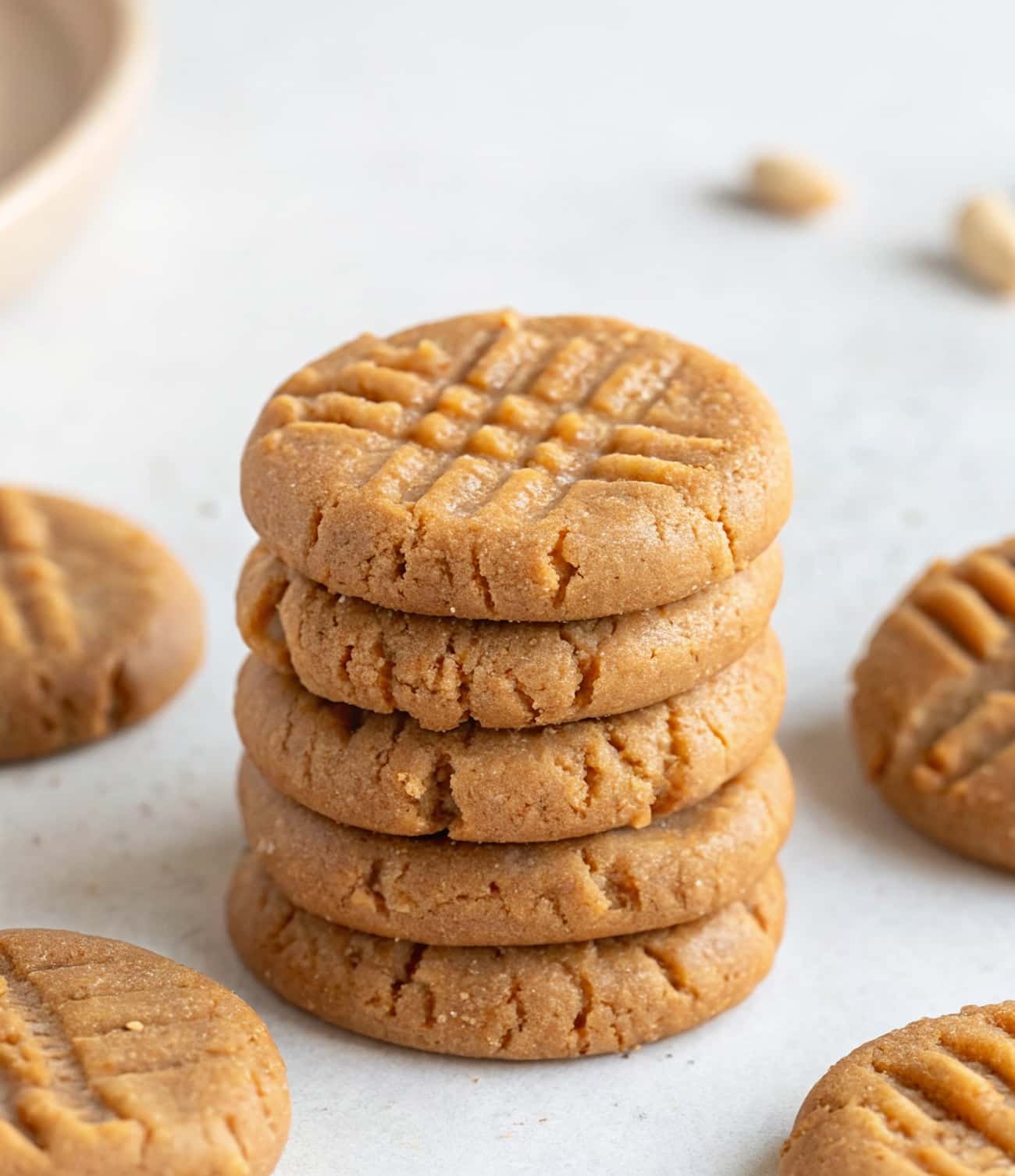 3 ingredient healthier no bake peanut butter cookies stacked on parchment