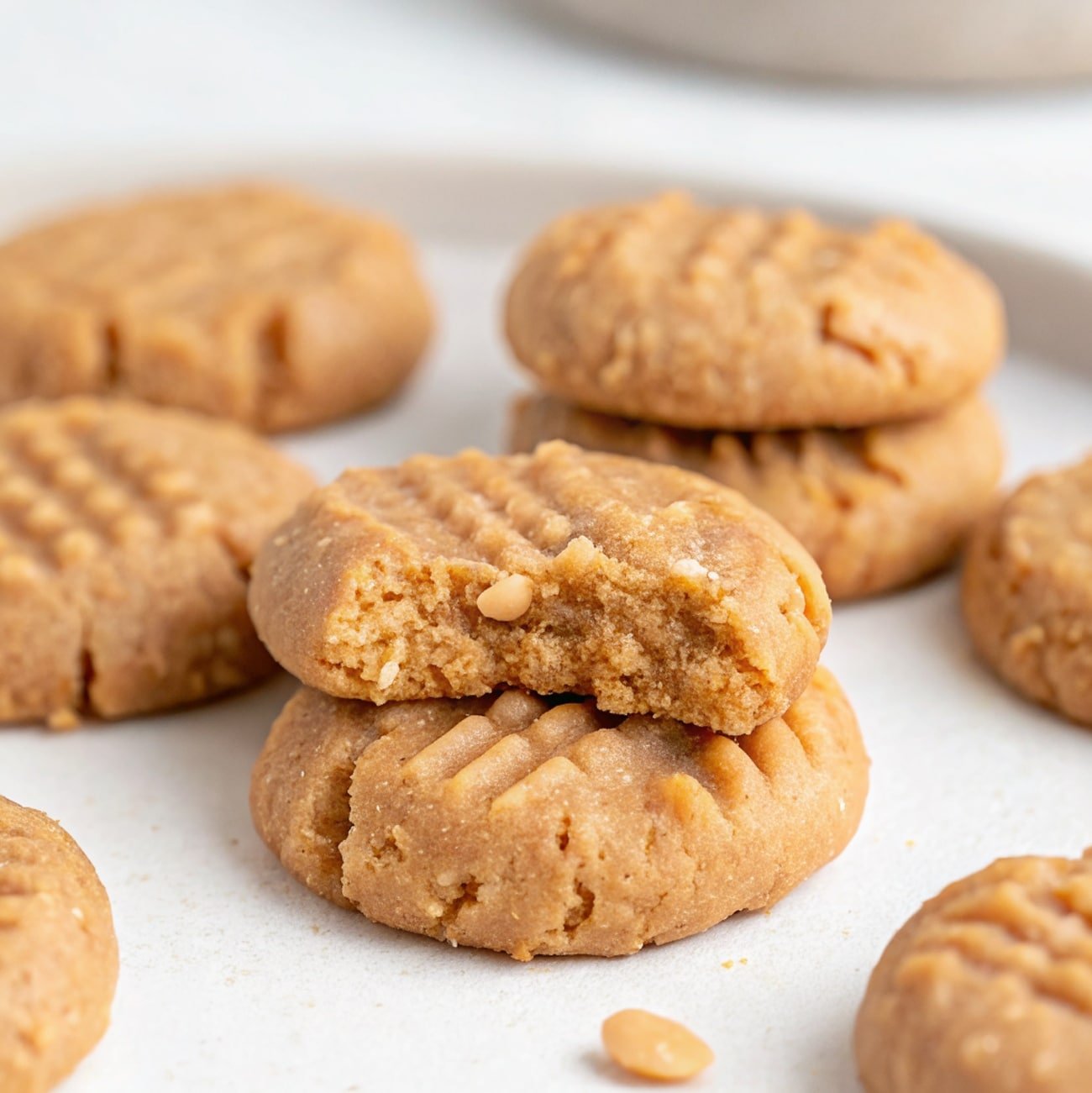 3 ingredient healthier no bake peanut butter cookies stacked on parchment