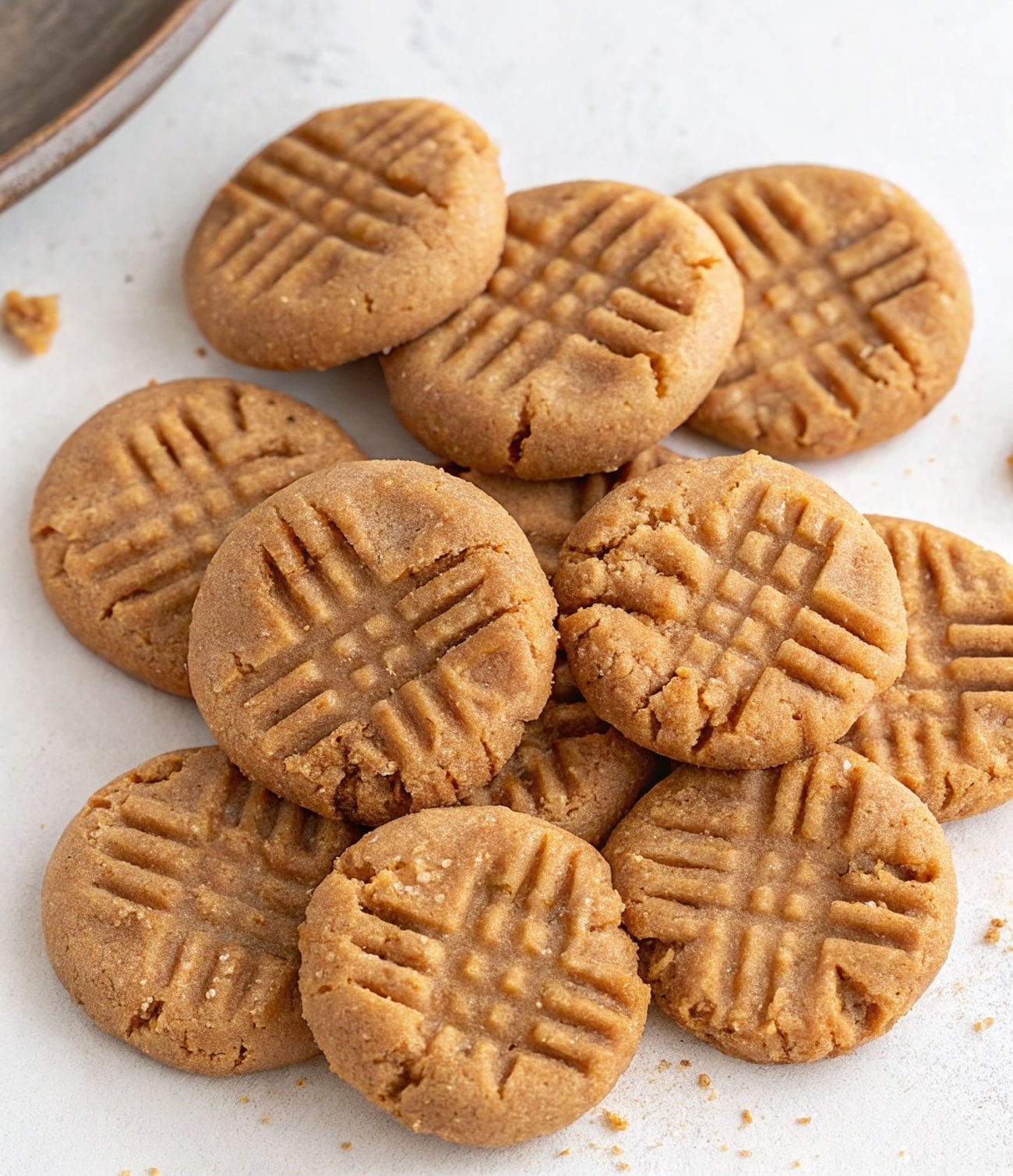 3 ingredient healthier no bake peanut butter cookies stacked on parchment