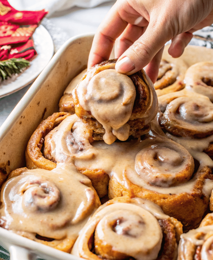 Gluten free vegan gingerbread cinnamon rolls with frosting.